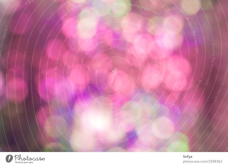 Abstract blur sequin dress color bokeh light background. Pink and green shades soft wallpaper shiny design circle glowing effect bright beautiful disco abstract