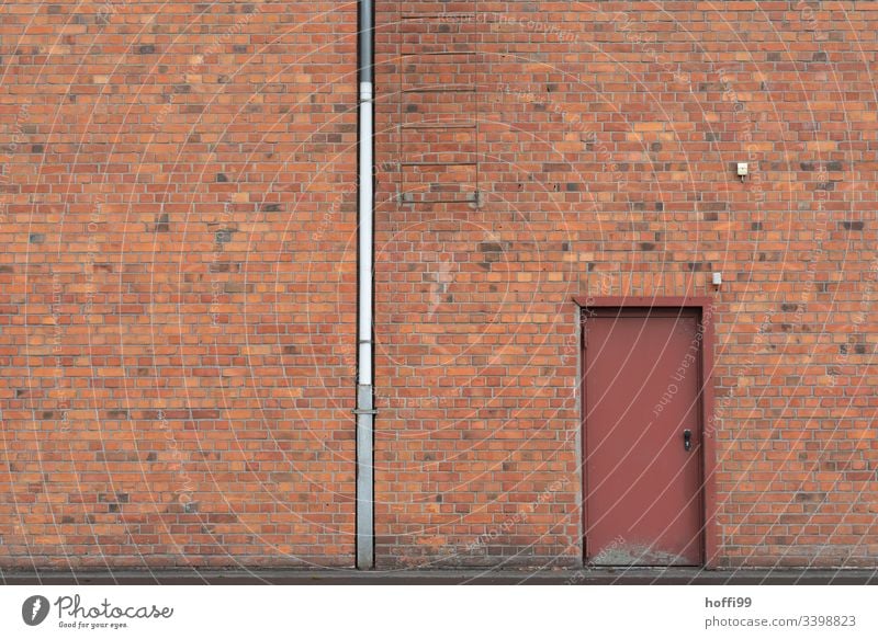 Red brick facade with downpipe, door and ladder clinker facade brick wall red brick Downspout Door Symmetry Window Venetian blinds Closed Warehouse Depot