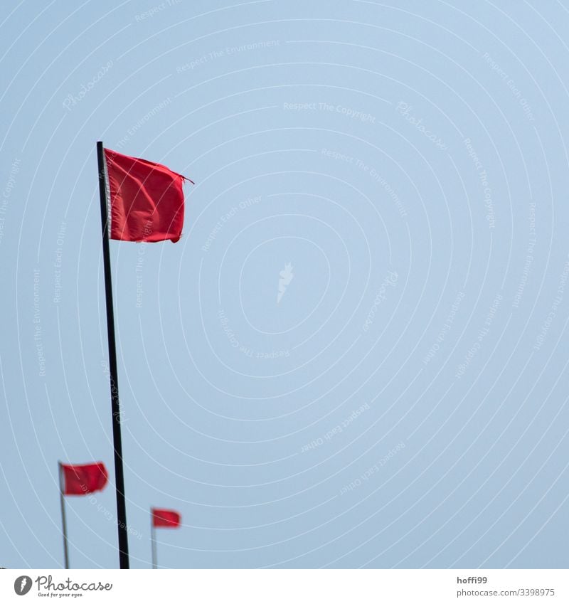 three red flags Central perspective Flag Flagpole Red Maritime Wild Fresh Beautiful weather Cloudless sky Simple Colour Blue Arrangement Rescue Light