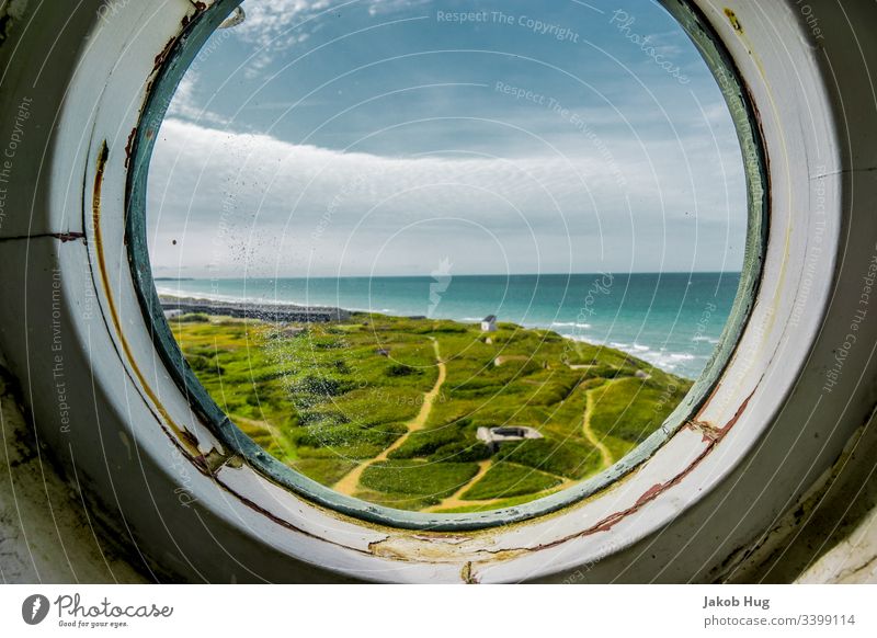 View from the round window of a lighthouse to the coast of Denmark Window Airplane Sky Mirror aviator Vantage point farsightedness Clouds Landscape Porthole