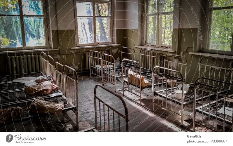 empty children's beds in an abandoned kindergarten house with peeling walls in Chernobyl abandoned house accident building dangerous deserted ecology empty beds