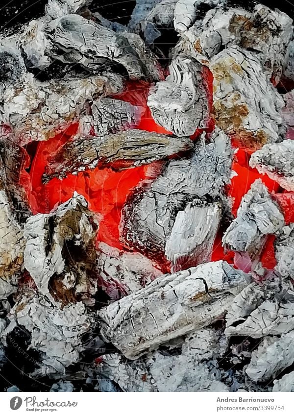 Incandescent coals in reddish and orange tones hot nobody temperature black closeup campfire ember texture spark heat flaming ablaze background wood live