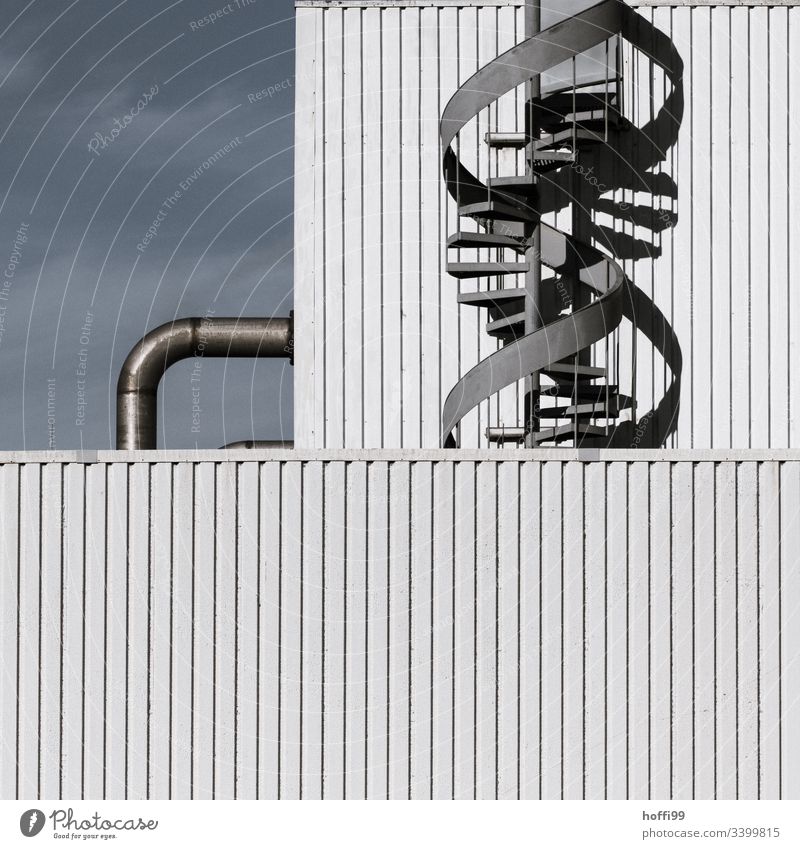 Spiral staircase with pipeline on industrial facade Emergency exit Winding staircase Facade Steel Industrial plant Warehouse Stairs Industry Pipe system