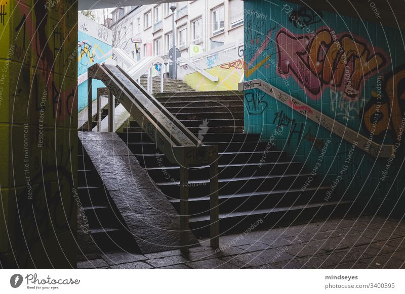 Staircase with graffiti Stairs Banister Dark Graffiti urban city views Underpass Town Darmstadt Arrow colors stagger dark & gloomy variegated Colour street art