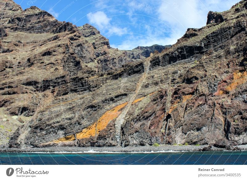 View on the steep coast of Los Gigantes on canary island tenerife with rocks in different colors canary islands los gigantes spain mountain range background