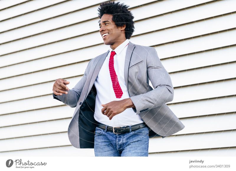 Happy Black Businessman wearing suit dancing outdoors. black businessman happy curly afro joy you hair african male adult portrait american person casual guy