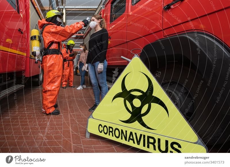 Firefighters in disease control suits examine people suspected of being infected with corona virus coronavirus covid-19 Virus Illness pandemic Epidemic Mask