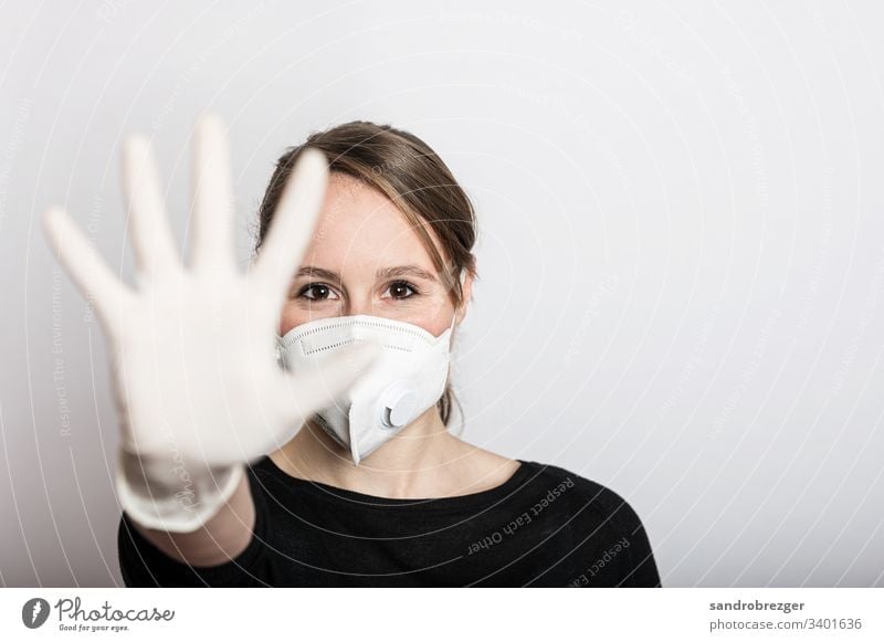 Woman with face mask and gloves stops the Corona Virus epidemic coronavirus covid-19 Illness pandemic Epidemic Mask guard sb./sth. disposable gloves
