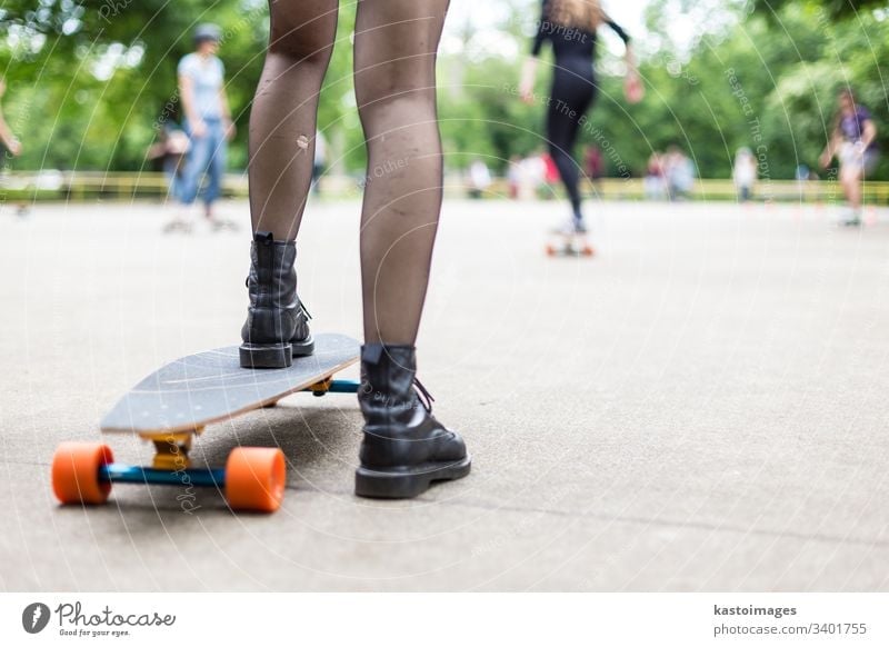 Active hipster man skateboarding in park - a Royalty Free Stock