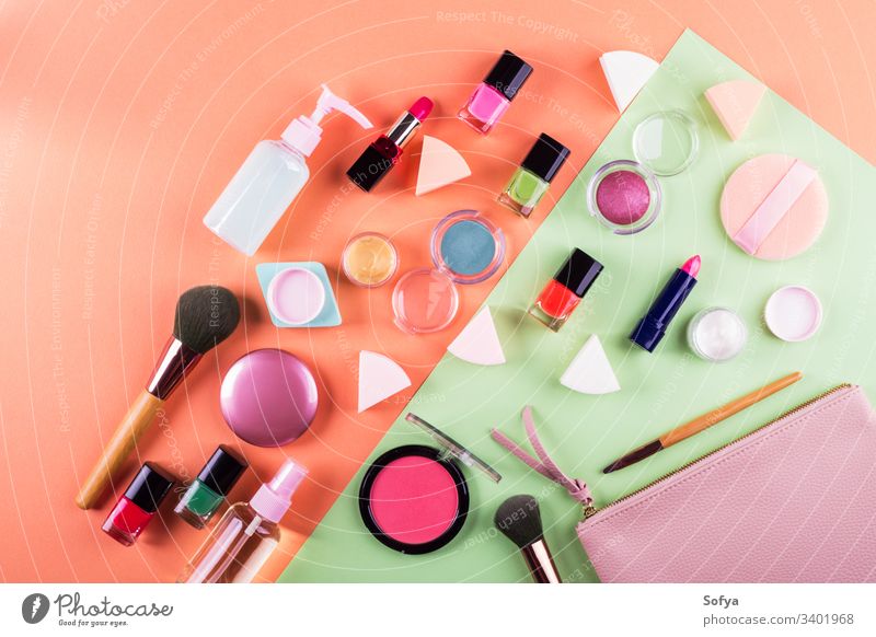 Make up accessories on cantaloupe orange and mint green paper background. Flat lay make up flat lay beauty products fashion color pink woman design geometry