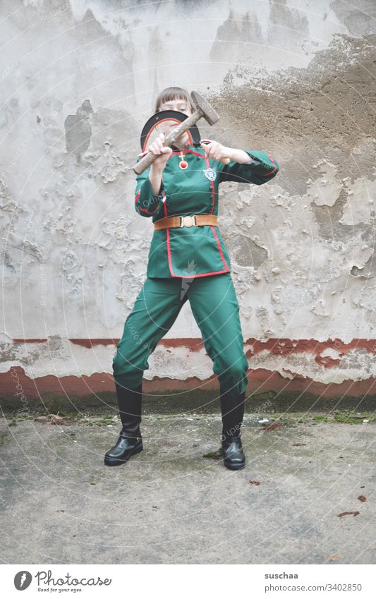 youth in uniform plays with sickle and hammer Youth (Young adults) teenager Young woman Uniform Soldier comedian comic fun Strange Funny Human being