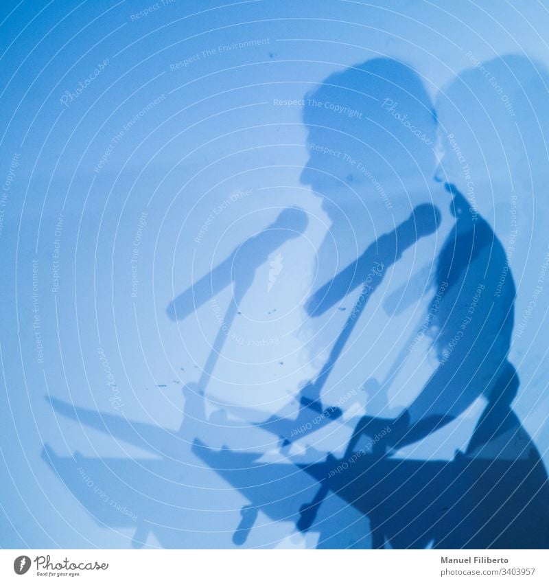 Double shadow of a person speaking through a microphone on a blue wall speech concert silhouette male music party live meeting performance pop singer song