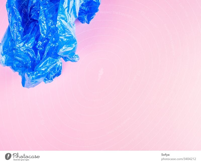 Crumpled blue plastic trash bag on pink background plastic bag plastic free recycling garbage flat lay pollution crumpled stop bags zero waste recycle