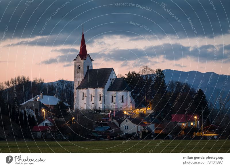 Church in Turciansky Dur village of Turiec region, Slovakia. landscape countryside rural architecture church historical heritage evening sunset mountains