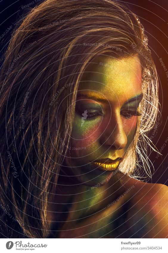 Portrait of a woman painted in gold Midas carnival halloween portrait hair vertical copy space female girl european caucasian people person face make up artist