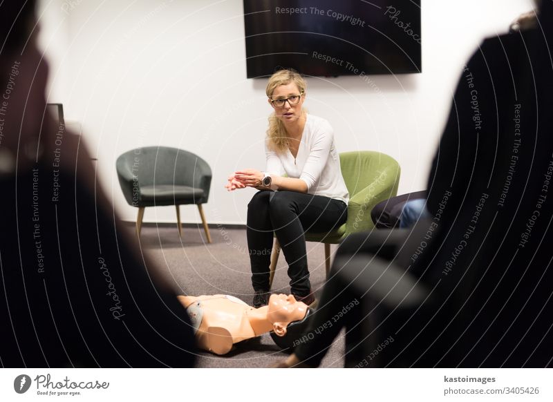 Instructor teaching first aid cardiopulmonary resuscitation course and use of automated external defibrillator on CPR workshop. training aed arrest attack