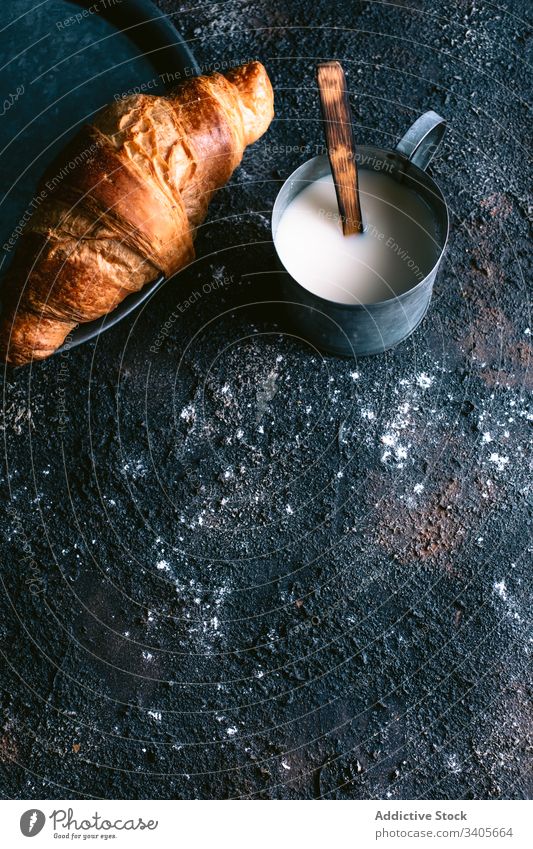 Croissant and milk on table croissant breakfast morning rustic mug fresh food cuisine pastry bun rough messy dirty homemade yummy gourmet meal organic baked