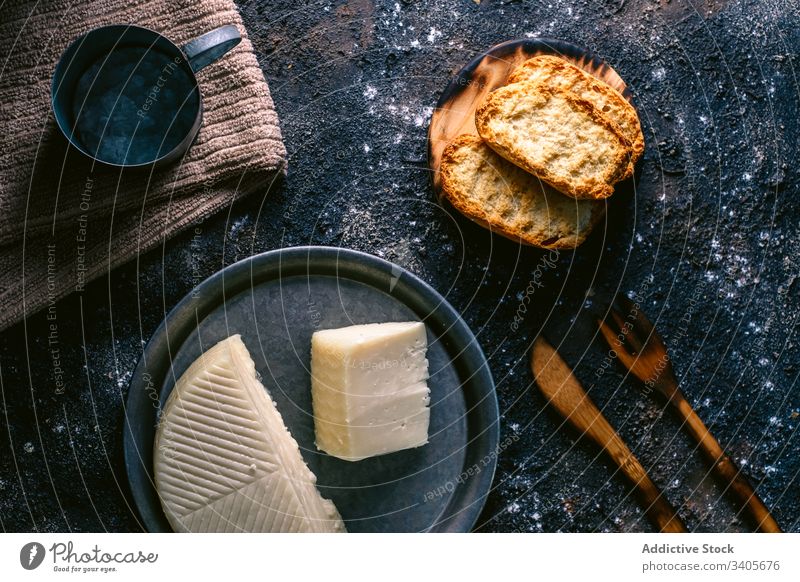Cheese and toasts on messy table cheese kitchen food utensil napkin rustic cuisine tasty meal homemade gourmet fresh delicious nutrition culinary organic