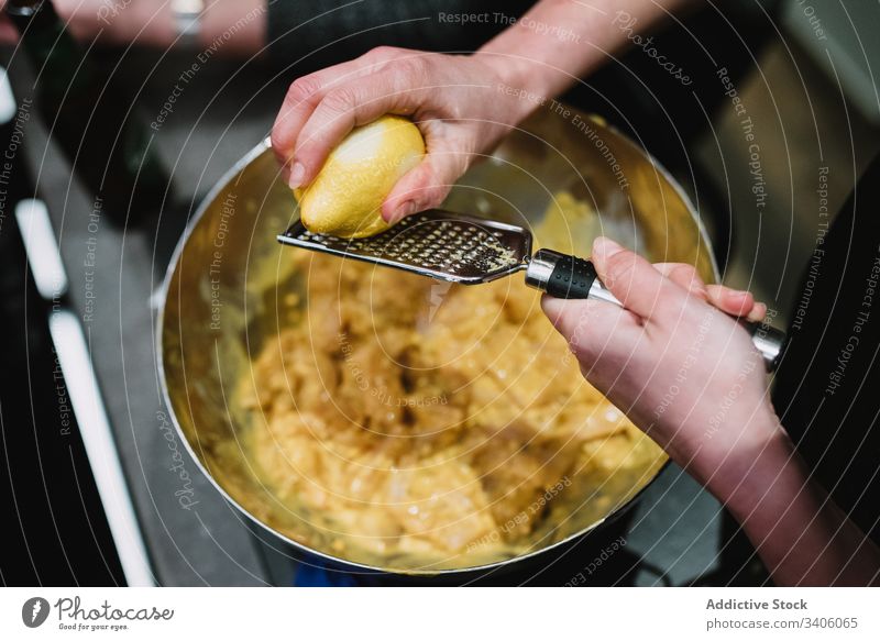 Crop person scratching lemon in kitchen peel potato table lesson cook food ingredient fresh organic cuisine prepare natural meal nutrition chef course school