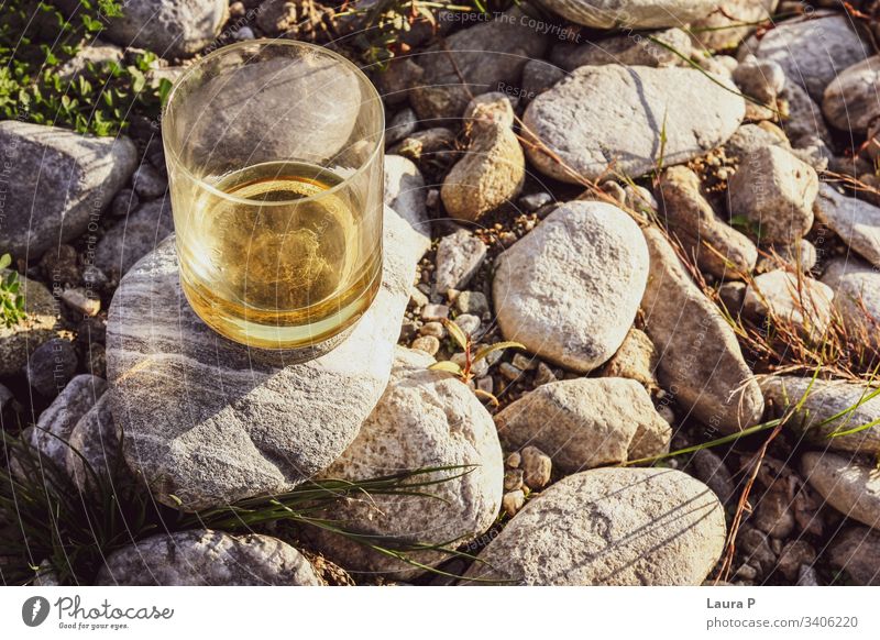 Close up of a glass with whiskey on some rocks close up rum Alcoholic drinks Beverage Bourbon Drinking nature concept relax relaxation Refreshment