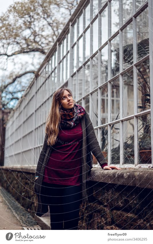 Young woman contemplating an urban greenhouse perspective cultivation grow land countryside culture interior girl food warmth farm gardening produce nutrition