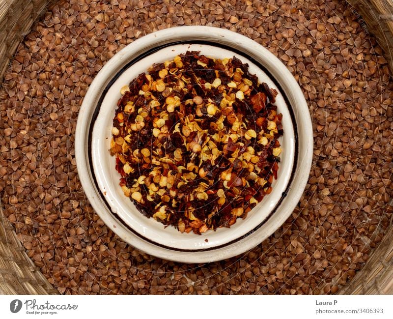 Close up of condiments in a round bowl - chilli and buckwheat close up spices herbs rustic delicious food nutrition vegetable raw diet healthy Vegan diet