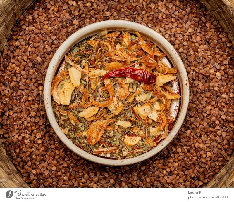 Close up of mixed condiments in a round bowl - seen from above Cooking food Vegan diet herbs and spices garlic nutrition delicious rustic chilli buckwheat