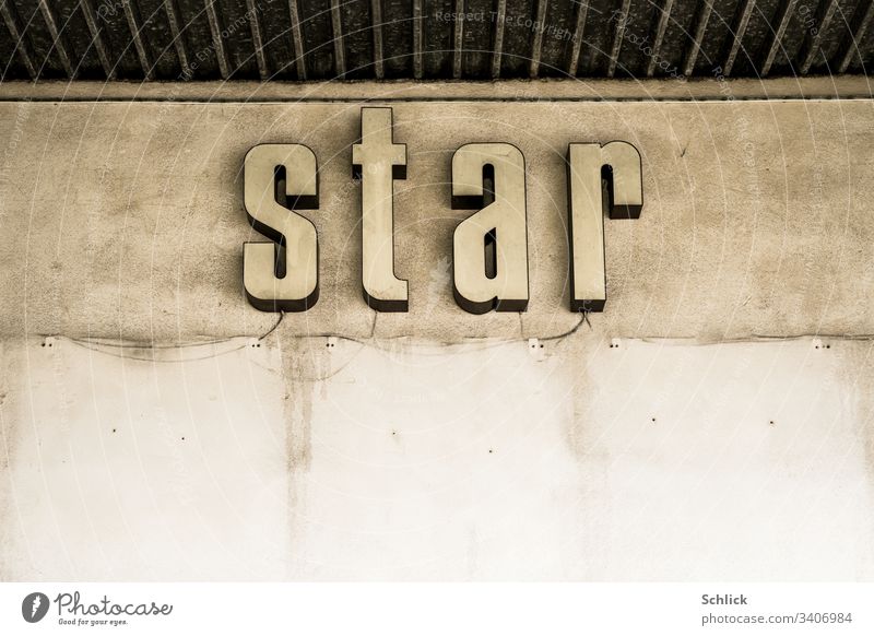 Old neon sign Word star on concrete wall Starling Wall (building) Concrete dilapidated publicity Neon sign background Gloomy colourless Advertising bankrupt