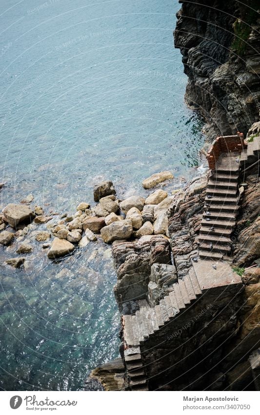 Stairs leading to the sea entrance on a rocky cliff adriatic background bay beach beautiful birds blue coast coastline concrete empty europe italy landscape
