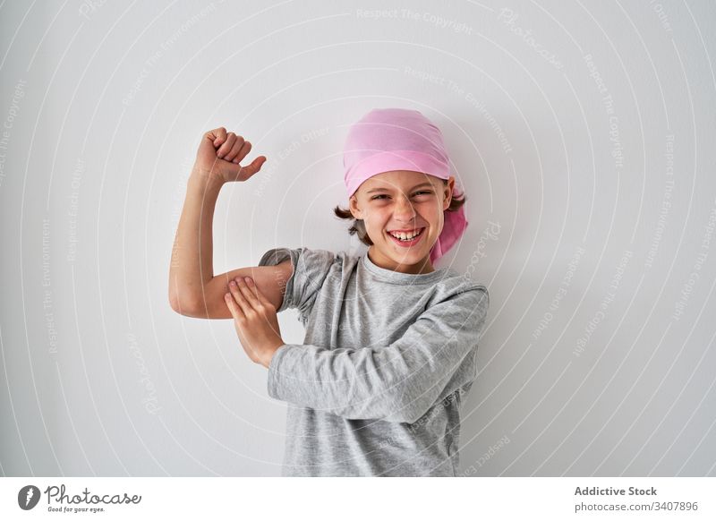 Courageous little boy against cancer at wall child diagnosis scream raise fist sick room male fight small strength willpower patient optimist gesture grimace
