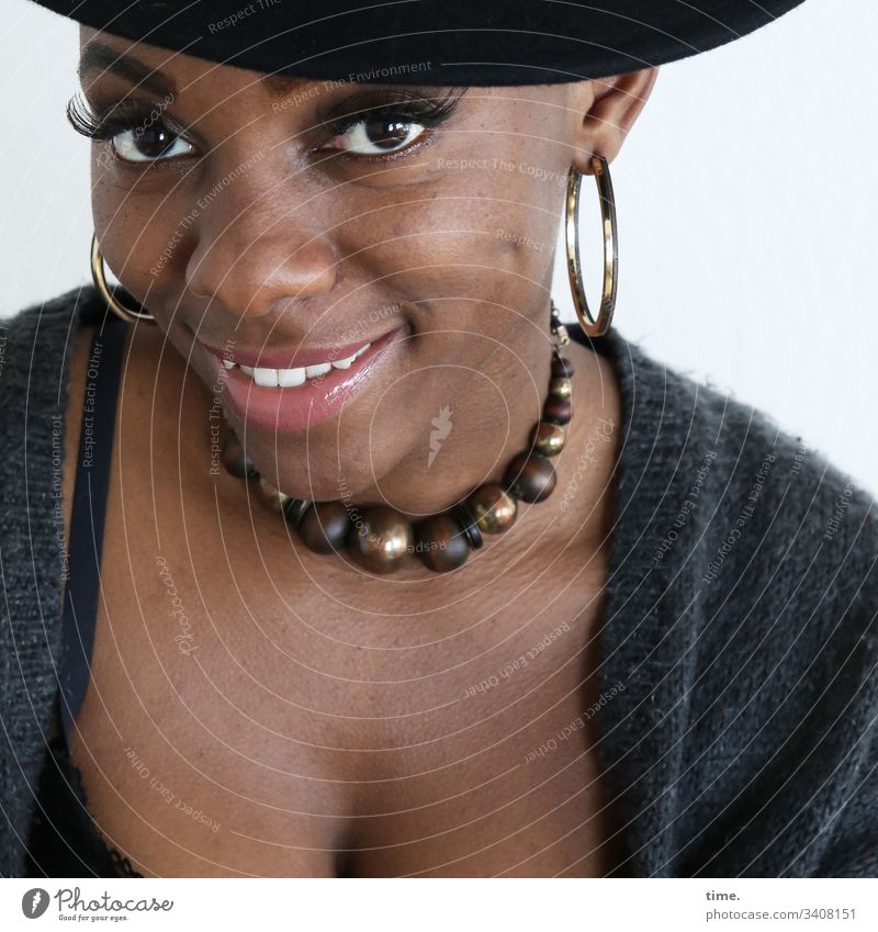 Tash feminine Looking Woman self-confident Beautiful earring Front view Chain Jacket Wool look see Hat