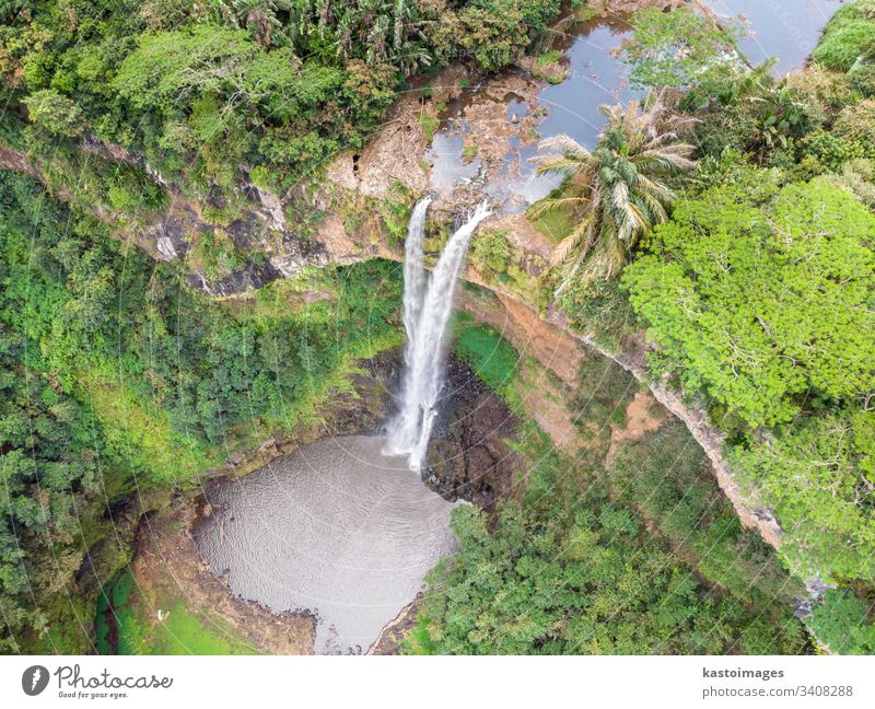 Aerial top view perspective of Chamarel Waterfall in the tropical island jungle of Mauritius. chamarel waterfall mauritius africa flowing forest green landscape
