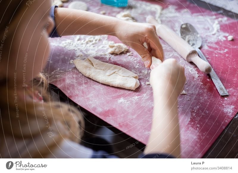 Close up of child hands next to a rolling pin, playing with dough desert Preparation Raw Kitchen Close-up adorable cute sweet close up little baking cooking