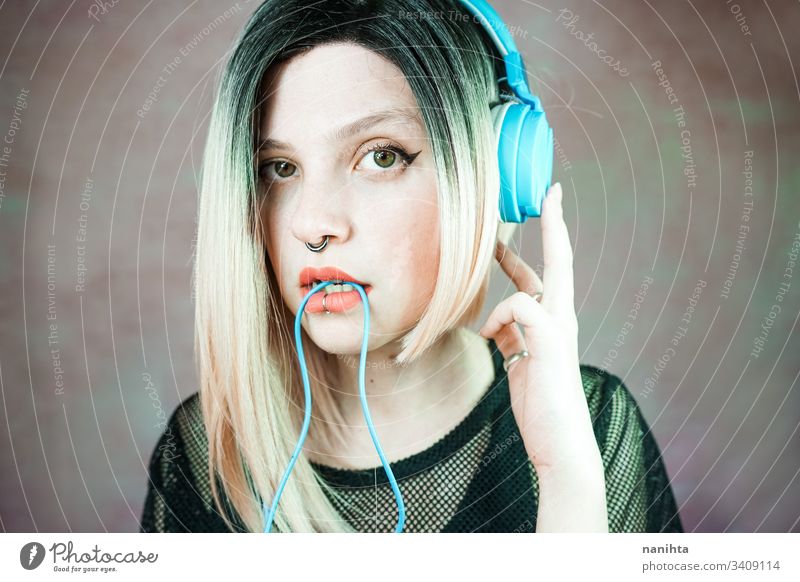 Positive man listening music with headphones, dancing on dark neon  background. Stylish student guy enjoying life, active energy, inspired  dance concept - a Royalty Free Stock Photo from Photocase