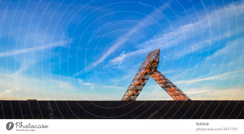 Saarland Saarpolygon on the Duhamel slagheap glows red in the first sunlight Saaar polygon Germany Morning Glow Moon Blue sky Landmark Berhalde Slagheap Mining