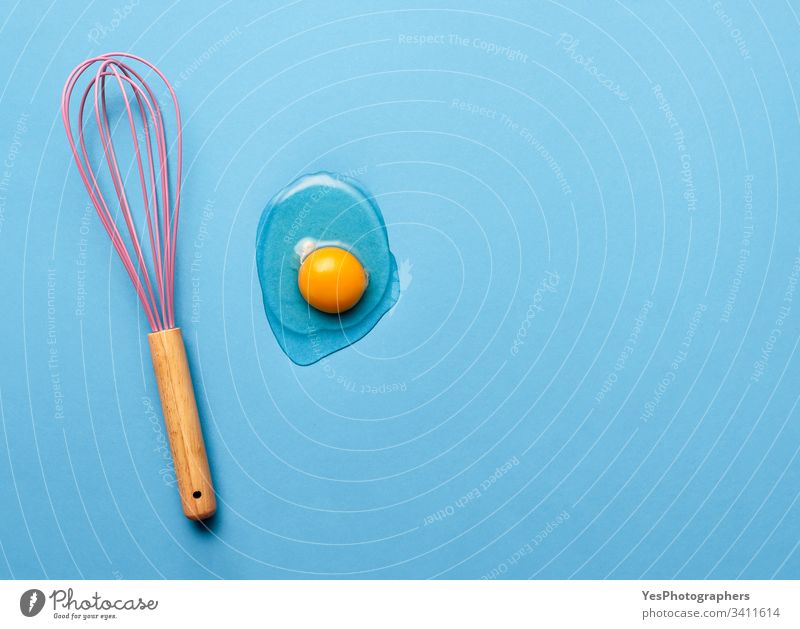 Baking concept with a whisk and egg yolk baking blue colorful cooking flat lay food ingredient kitchen kitchenware minimal minimalist mixer protein seamless
