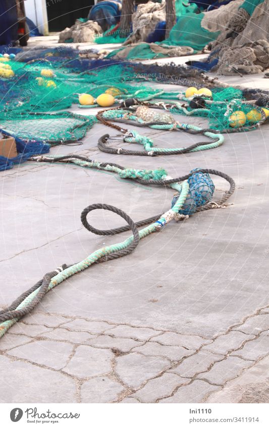 rope team | colourful fishing nets with thick coloured ropes and fishing balls lie on quay wall Sea Colours Disperse Blue Turquoise Yellow Fishing net Loop