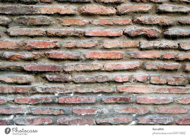 pattern texture of old vintage orange brick wall close up antique architecture background blank block building cement closeup color detailed grunge material