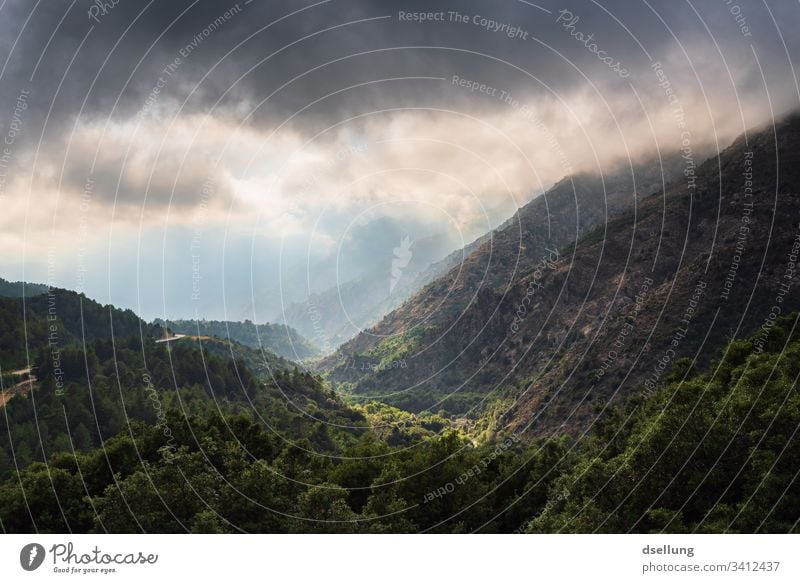 View of several levels of mountains with sunrays in cloudy weather Beautiful weather Expedition Climate change Environment Blue Weather Panorama (View) Light