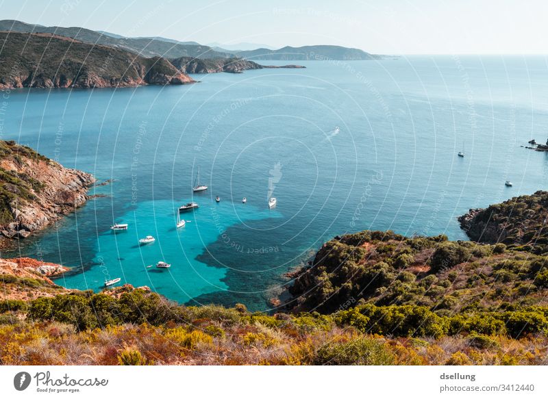 Turquoise sea with shipping traffic from a peninsula with mountain arms Blue Green Brown Landscape Vacation mood Ocean Corsica Boating trip Sky Relaxation