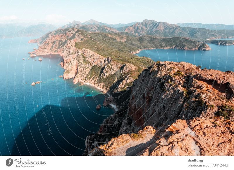 Turquoise blue water with rock arm in the foreground Perspective colors Contrast Deserted Colour photo Esthetic Exterior shot Green Brown Twilight Shadow Nature