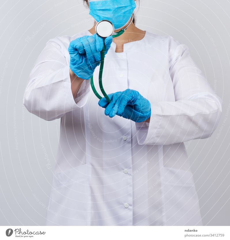 medic woman in a white coat and mask, wearing blue medical latex gloves adult care caucasian check clinic concept doctor equipment female girl hand health