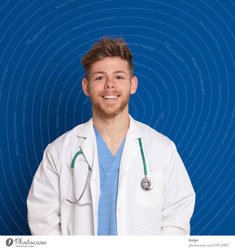 Attractive doctor with white lab coat on a blue background uniform health review stethoscope medical happy smile joyful positive relaxed person medicine