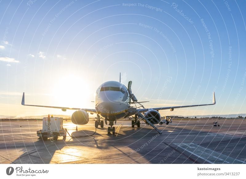 Passenger airplane on airport runway at sunset. transportation travel business jet sky airline engine terminal flight aircraft departure wing arrival aviation
