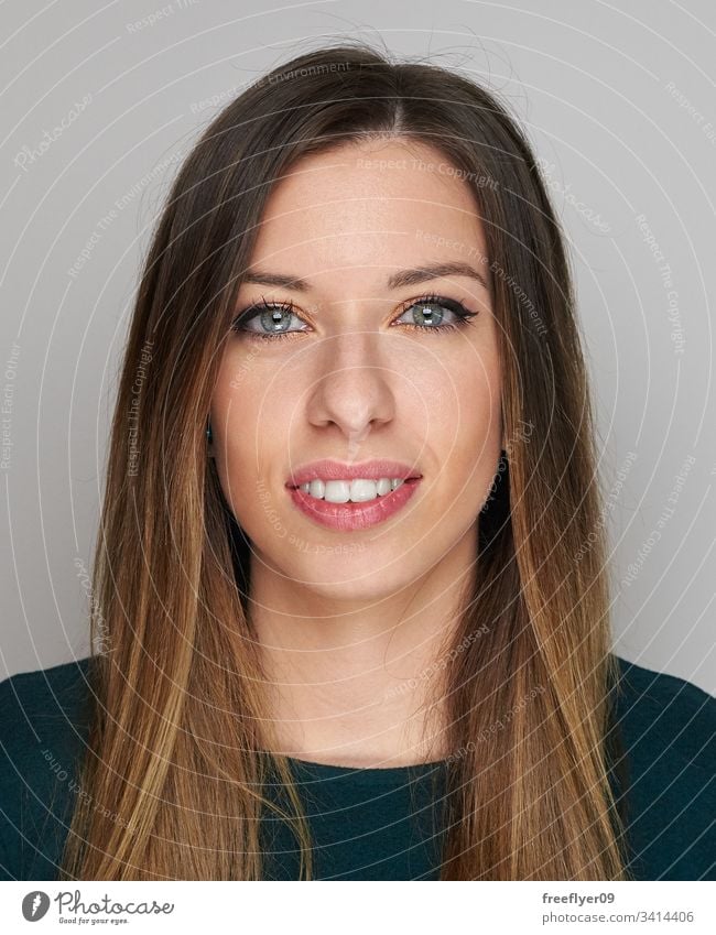 Portrait of a woman on a grey background portrait white dark hair hard light blue eyes attractive sexy vertical copy space copyspace long haired female