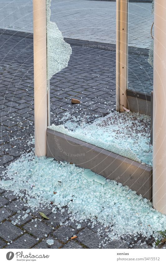Broken glass at a smashing telephone booth shards Phone box Aggression Crime scene Criminality Force policy Copy Space bottom Paving stone Destruction Stone