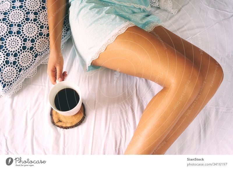 Woman holding mug of hot tea. Lazy cozy morning in bed. Flat lay woman  accessories with letter, envelope, smartphone, perfume. 7463386 Stock Photo  at Vecteezy