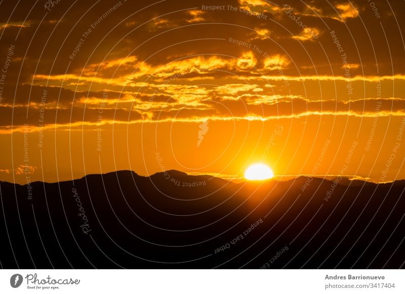 Sunset over mountains outdoor clouds morning sunrise dark storm scenic dramatic orange landscape background panoramic landscape thunderstorm danger stormy