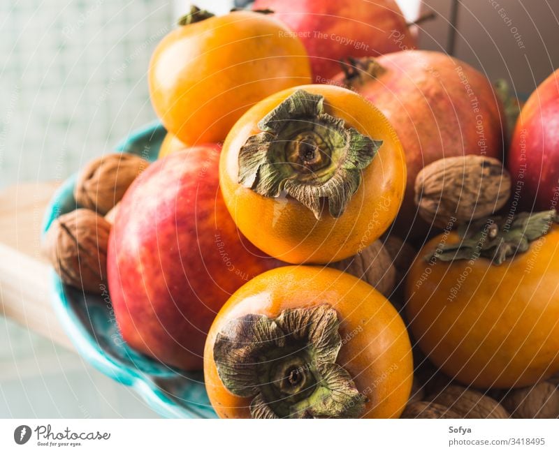 Autumn fresh fruit food in the kitchen autumn fall persimmon background vegan vegetarian pomegranate apple harvest healthy organic eat seasonal winter orange