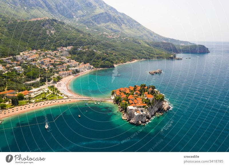 Small private peninsula on the coast of Montenegro Sveti Stefan Coast Ocean Vacation mood vacation travel Sightseeing Health Spa Beach Rock Sailboat Mountain